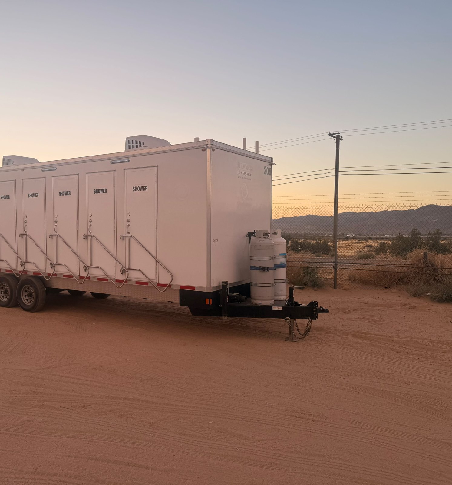 Shower trailer set up on a remote desert jobsite in Nevada with open ground around it