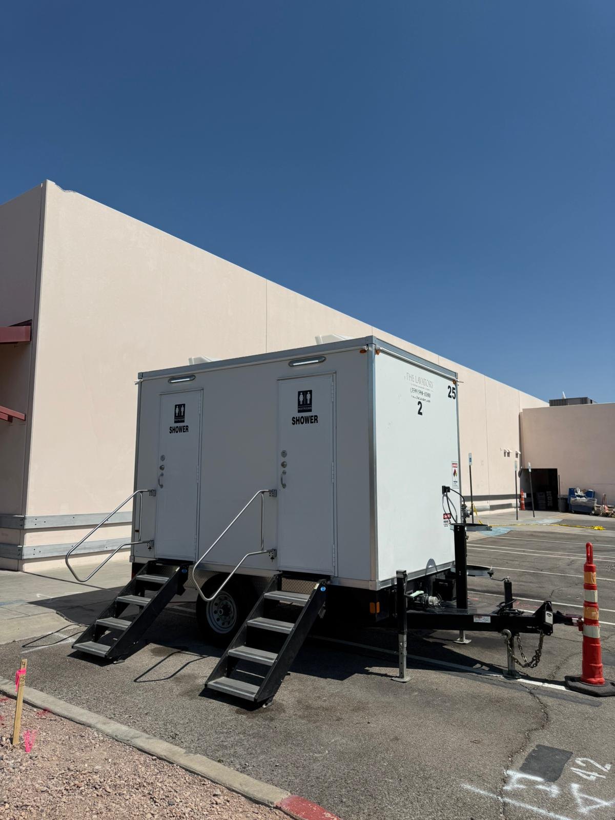 Mobile shower trailer parked and leveled on a Nevada worksite with the entry steps down
