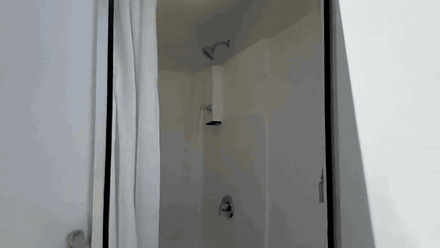 Animated walkthrough of a mobile shower trailer interior showing a private stall, vanity and finished walls